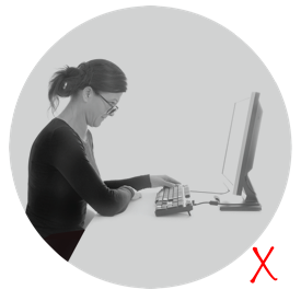 Dame med dårlig arbeidsstilling på grunn av feil avstandsbriller foran dataskjerm